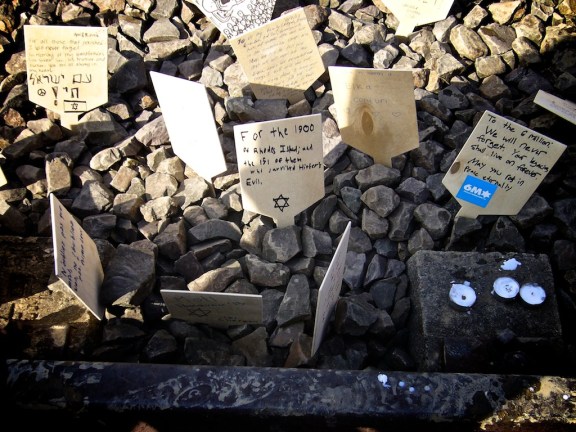 Small sign written by Noah Botman placed on the rail track between Auschwitz and Birkenau “For the 1900 of Rhodes Island and the 151 of them who survived History’s Evil” (March of the Living, Poland, April 2013)