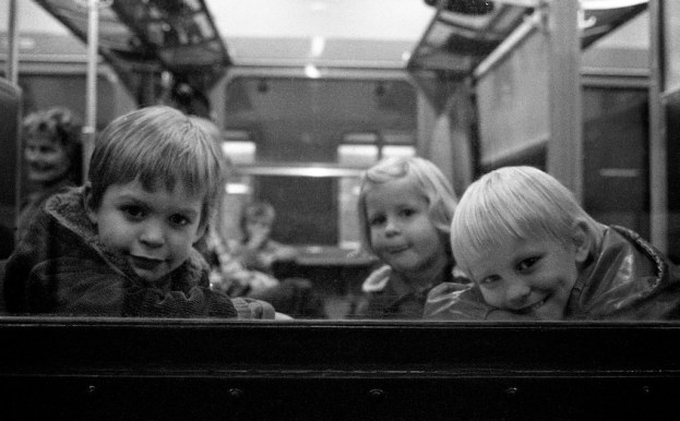 Children on the train to Brussels. Belgium, circa 1980. © Michel Botman Photography.